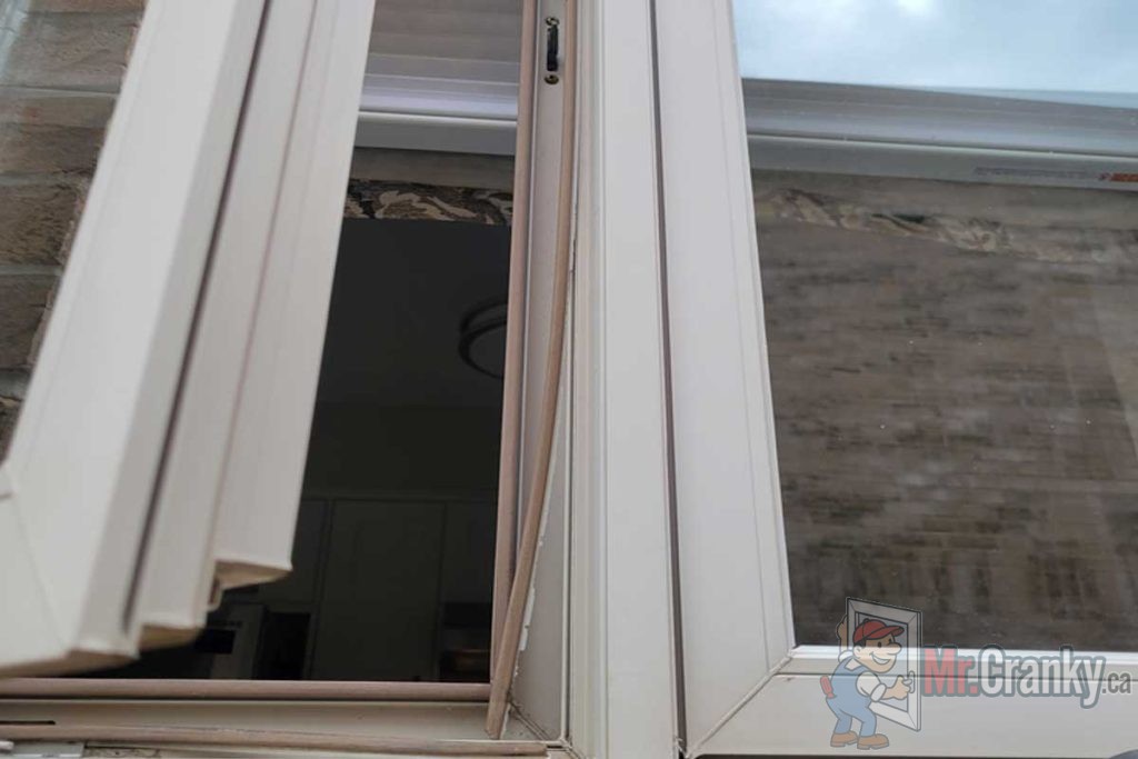 Weatherstrip hanging from window